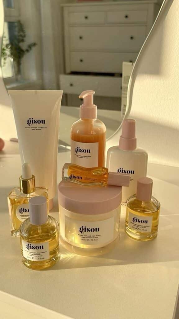 72010bb7cc3f5e00f6af14497b99862d Gisou hair care products on a sunlit vanity, featuring oils, mask, and wash for nourishing beauty routine. | Sky Rye Design Gisou hair care products on a sunlit vanity, featuring oils, mask, and wash for nourishing beauty routine.