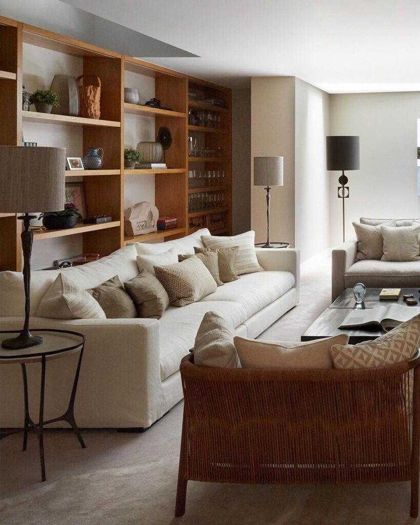 72edc7b89ad3f1544a6f2b9e54653c53 Modern living room with cozy white sofas, wooden shelves, and elegant decor elements. | Sky Rye Design Modern living room with cozy white sofas, wooden shelves, and elegant decor elements.