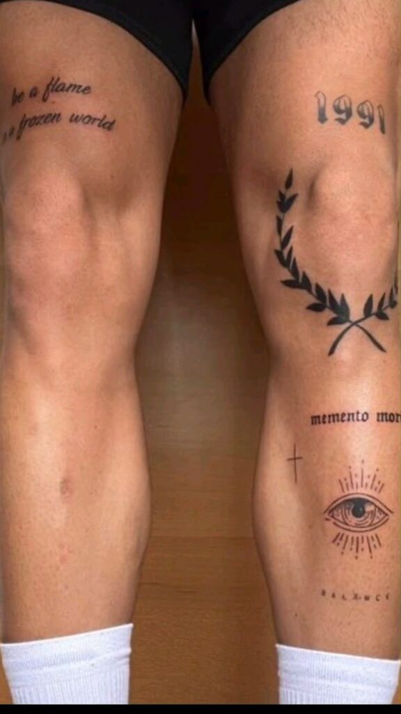 752d8a9a847467e143fbab54dbbd73ac Person's legs with various tattoos, including a wreath, eye, cross, and text phrases. | Sky Rye Design Person's legs with various tattoos, including a wreath, eye, cross, and text phrases.