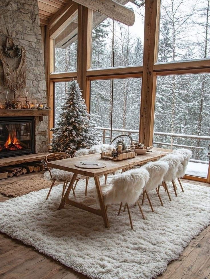 766ff367-0da0-412f-ae60-173ecbc7e8a0 Rustic dining room with fur chairs, stone fireplace, Christmas tree, and snowy forest view through large windows. | Sky Rye Design Rustic dining room with fur chairs, stone fireplace, Christmas tree, and snowy forest view through large windows.