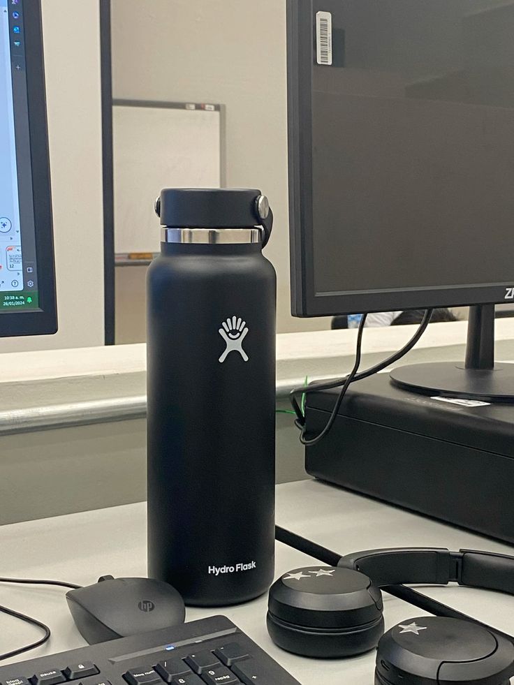77c79e854ab2610727d71936444d4fd5 Black Hydro Flask on an office desk with a computer monitor and headphones nearby. | Sky Rye Design Black Hydro Flask on an office desk with a computer monitor and headphones nearby.