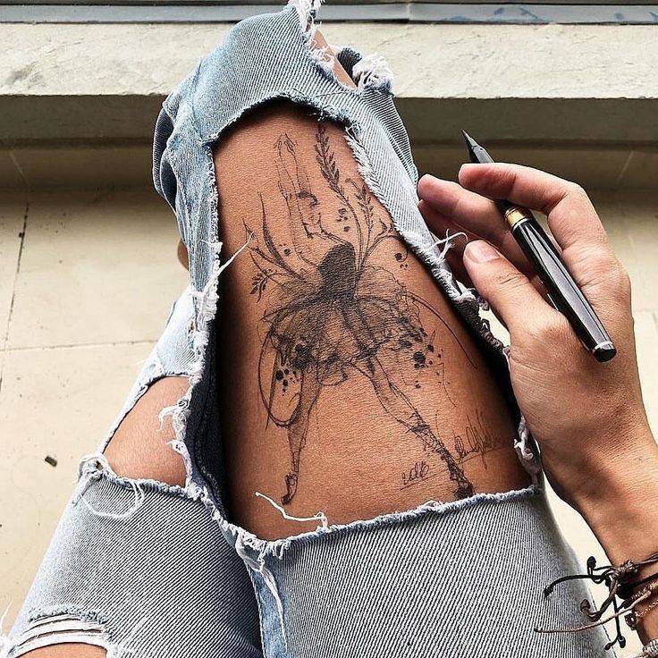 _ 8 Tattoo sketch of a ballerina on thigh, surrounded by ripped jeans, holding a pen for drawing. | Sky Rye Design Tattoo sketch of a ballerina on thigh, surrounded by ripped jeans, holding a pen for drawing.