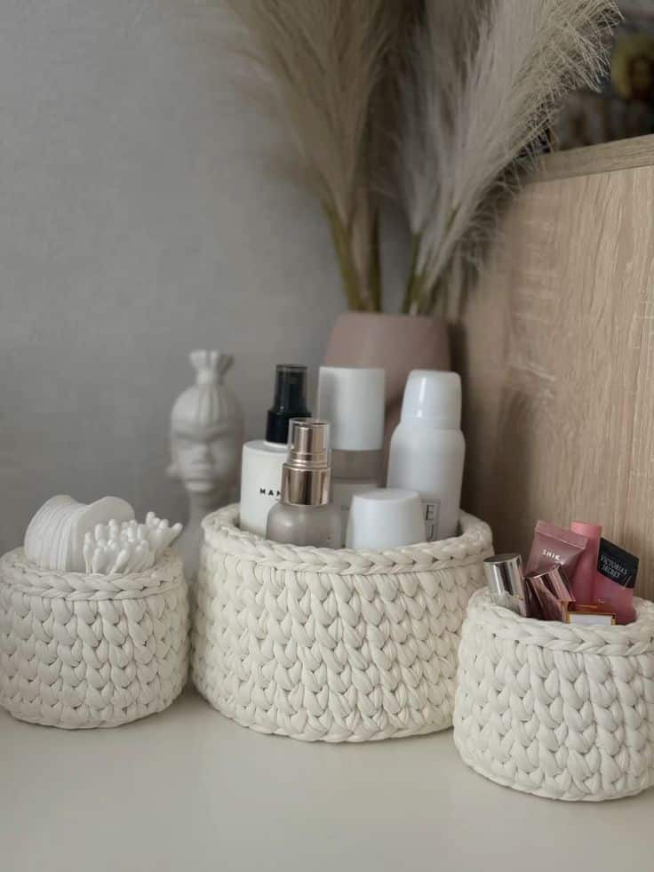 81103000-a8e3-411f-a71b-882a5a9d17b1 Wicker baskets with skincare and beauty products on a wooden surface, pampas grass in vase behind. | Sky Rye Design Wicker baskets with skincare and beauty products on a wooden surface, pampas grass in vase behind.