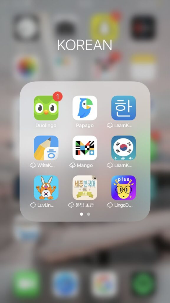 Folder of Korean learning apps including Duolingo, Papago, and Mango on a smartphone screen.