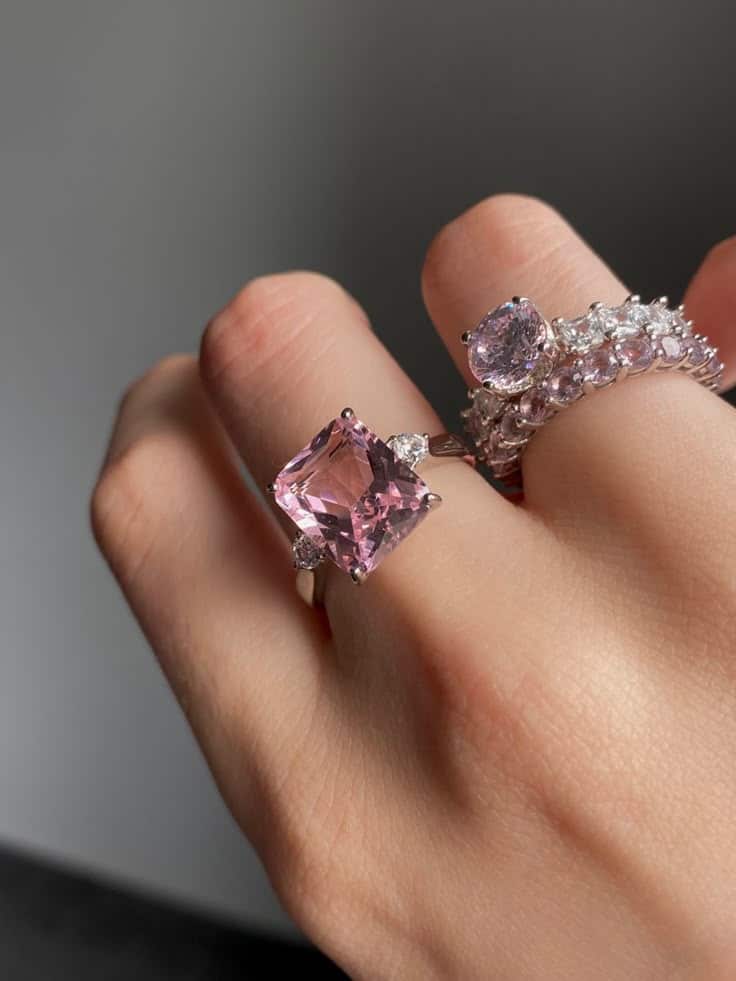 8a3508d2-f830-4e6e-84eb-27c9662dda9a Elegant hand wearing pink gemstone and diamond rings, showcasing luxury jewelry. | Sky Rye Design Elegant hand wearing pink gemstone and diamond rings, showcasing luxury jewelry.