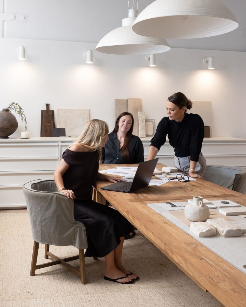 8ab7322bc63cddf662e8481d3097f8bd Team collaboration in modern office, discussing design projects at a wooden table with laptop and samples. | Sky Rye Design Team collaboration in modern office, discussing design projects at a wooden table with laptop and samples.
