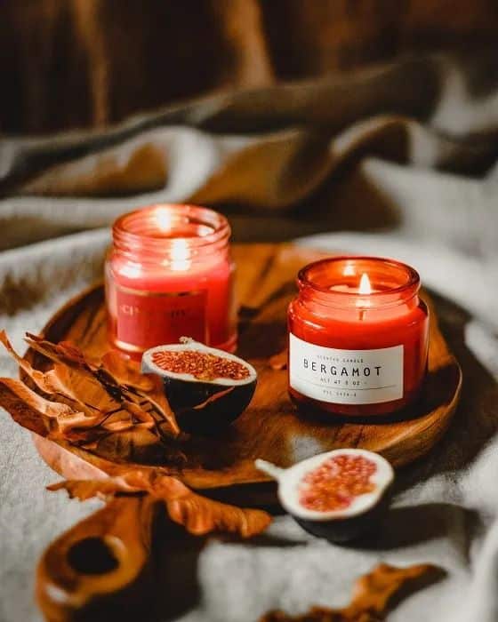 9 Tips to Create a cozy New Years Vibe in Your Dorm Room - miss mv Cozy setting with lit bergamot and fig-scented candles on a wooden tray, accented by dried leaves and fresh figs. | Sky Rye Design Cozy setting with lit bergamot and fig-scented candles on a wooden tray, accented by dried leaves and fresh figs.