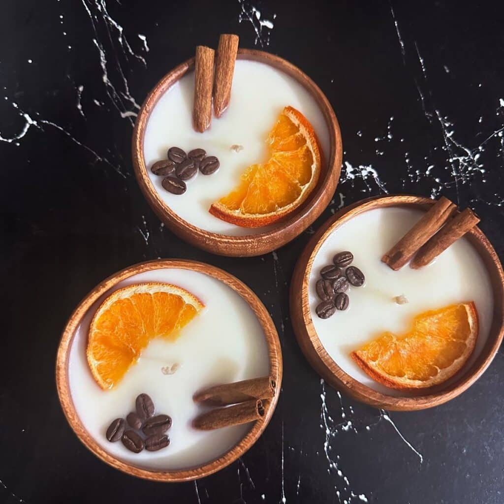 95c7f84a6b087c311c91568cbf7d36d2 Wooden bowls with white candles, garnished with dried orange slices, coffee beans, and cinnamon sticks on a dark surface. | Sky Rye Design Wooden bowls with white candles, garnished with dried orange slices, coffee beans, and cinnamon sticks on a dark surface.