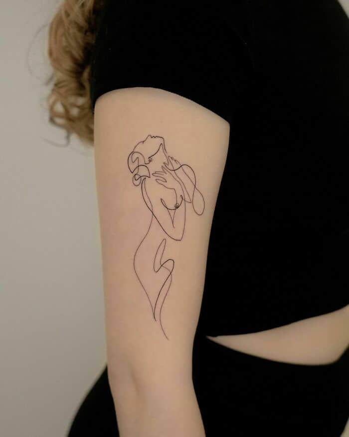 99 Single-Line Tattoos That Are Fine-Line Perfection Minimalist line art tattoo of a woman on the upper arm, expressing elegance and simplicity in black ink. | Sky Rye Design Minimalist line art tattoo of a woman on the upper arm, expressing elegance and simplicity in black ink.