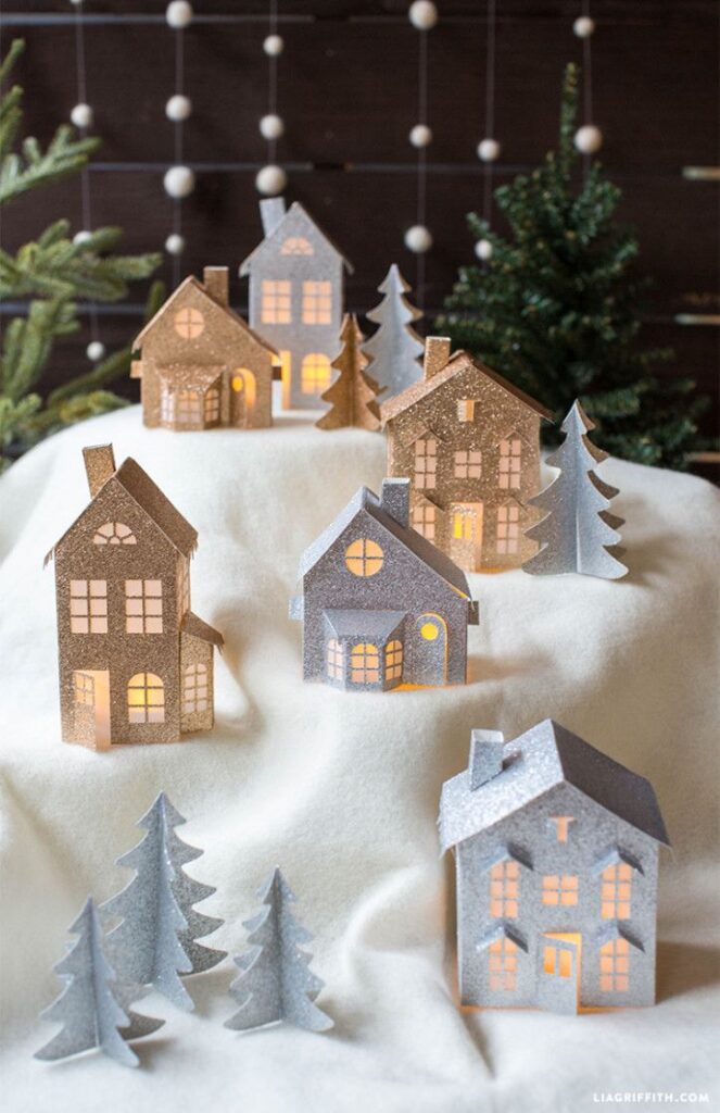 99af02a2a8119220f64448c977d3b6f7 Miniature lit Christmas village with glittery paper houses and trees on white snow-like fabric. | Sky Rye Design Miniature lit Christmas village with glittery paper houses and trees on white snow-like fabric.