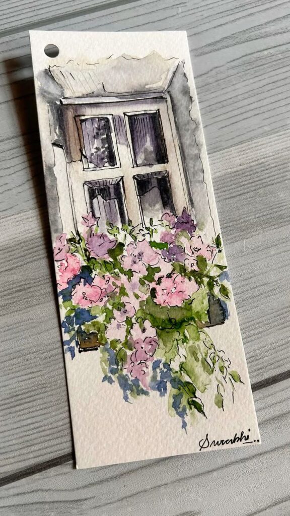 Watercolor painting of a window with pink and green floral arrangement, signed by the artist.