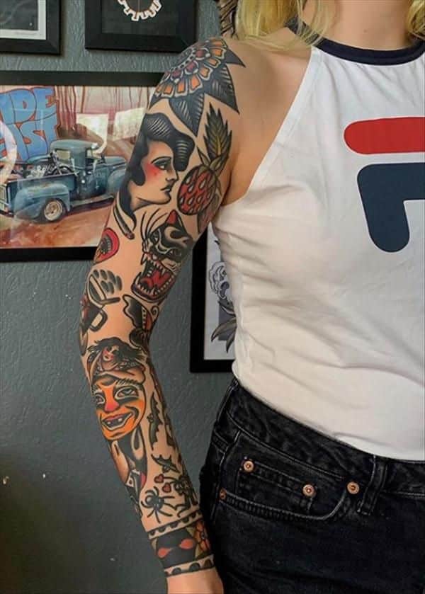 Person showcasing a colorful tattoo sleeve featuring various traditional designs in a gallery setting.