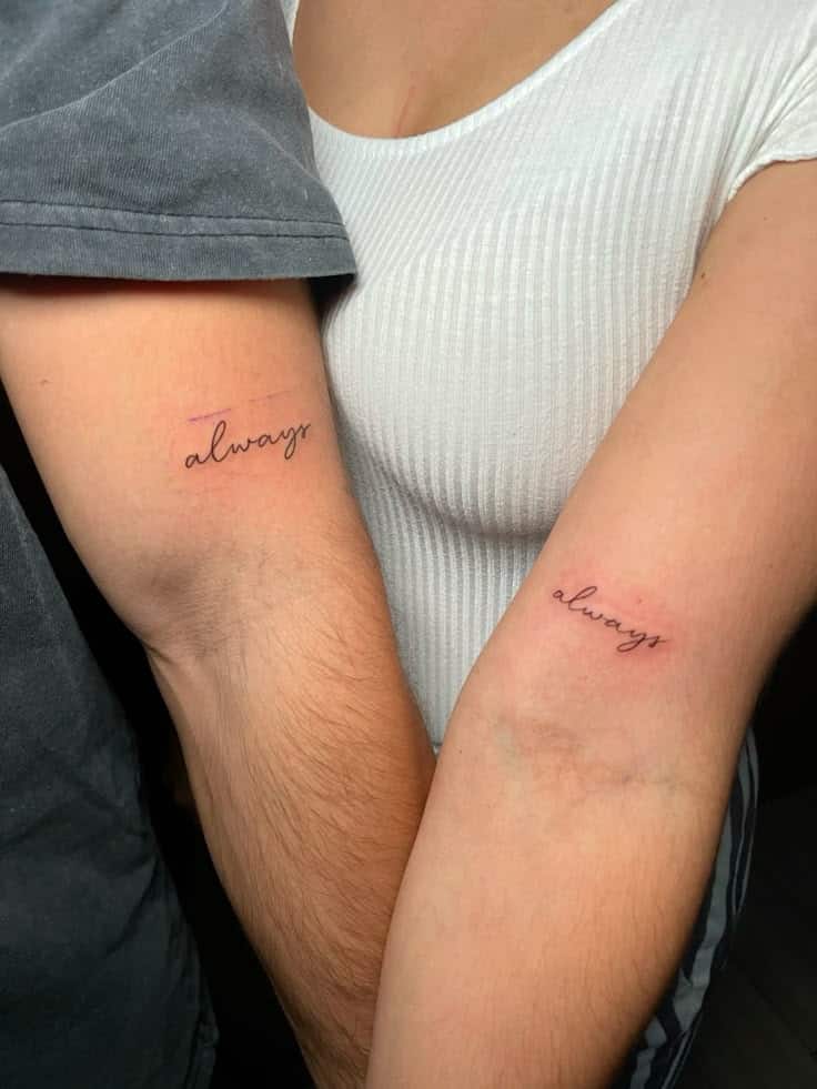 Matching always tattoos on two people's arms, symbolizing connection and commitment.