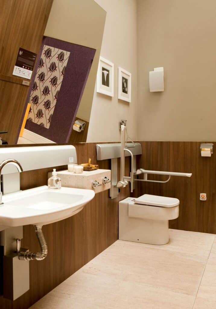 Accessible bathroom with modern design, featuring safety rails and stylish decor.