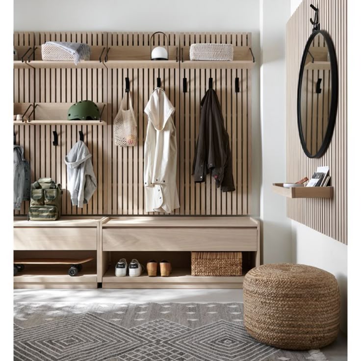 Batten White Oak Reversible Shelf Modern entryway with wooden slat wall, coat hooks, bench, pouf, and mirror for stylish storage and organization. | Sky Rye Design Modern entryway with wooden slat wall, coat hooks, bench, pouf, and mirror for stylish storage and organization.