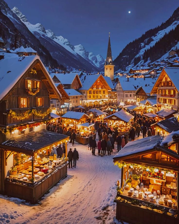 Best villages to visit in Switzerland during Christmas Snowy Christmas market at night with festive lights, wooden stalls, and a church steeple, surrounded by mountains. | Sky Rye Design Snowy Christmas market at night with festive lights, wooden stalls, and a church steeple, surrounded by mountains.