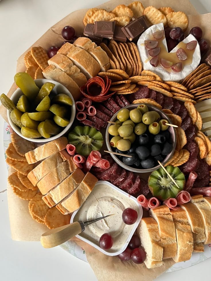 Charcuterie board🧀🍇🫒 Delicious charcuterie board with bread, olives, cheese, pickles, crackers, meats, and fruit. Perfect for snacking. | Sky Rye Design Delicious charcuterie board with bread, olives, cheese, pickles, crackers, meats, and fruit. Perfect for snacking.