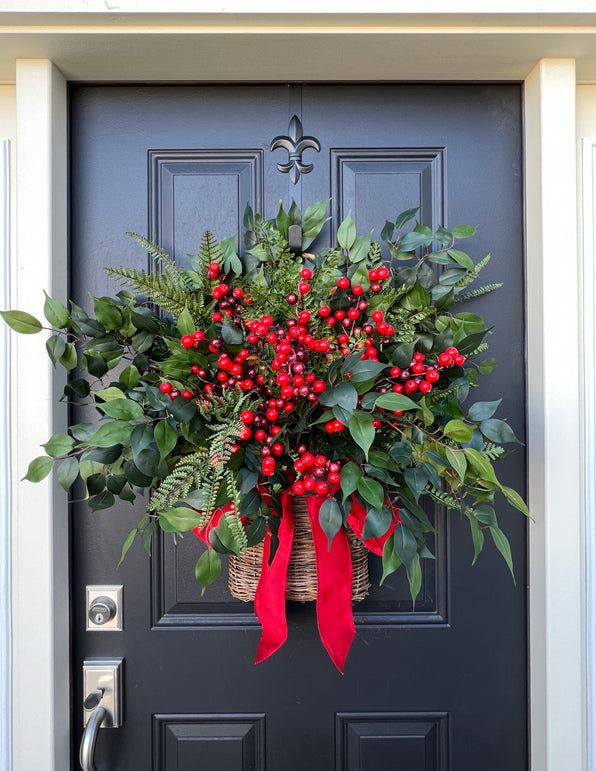 Christmas Basket for Front Door Festive holiday wreath with red berries and green leaves on a black door, accented by a bright red ribbon. | Sky Rye Design Festive holiday wreath with red berries and green leaves on a black door, accented by a bright red ribbon.