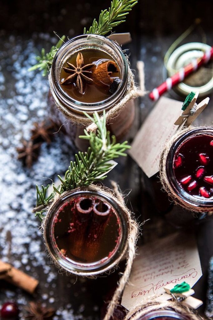 Christmas Edible Gift _ Simple Syrups Festive holiday drinks in mason jars with spices, garnished with rosemary, star anise, and cinnamon sticks. | Sky Rye Design Festive holiday drinks in mason jars with spices, garnished with rosemary, star anise, and cinnamon sticks.