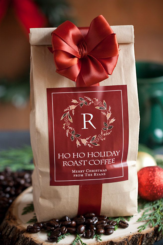 Coffee Bags _ Foil Coffee Bags Festive coffee bag with a red ribbon, labeled Ho Ho Holiday Roast Coffee, surrounded by coffee beans and decorations. | Sky Rye Design Festive coffee bag with a red ribbon, labeled Ho Ho Holiday Roast Coffee, surrounded by coffee beans and decorations.