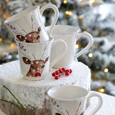 Costa Nova Deer Friends Mug - Mugs Teacups in White_Brown_Red _ Size 12oz_ _ Birch Lane Festive ceramic mugs with reindeer design stacked on snowy wood, perfect for holiday decor and winter drinks. | Sky Rye Design Festive ceramic mugs with reindeer design stacked on snowy wood, perfect for holiday decor and winter drinks.