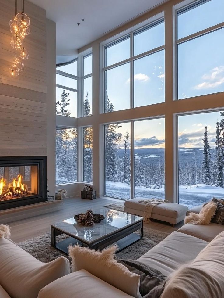 Cozy and Festive Living Room Christmas Decor Ideas for the Holiday Season Cozy living room with fireplace and large windows showcasing a snowy landscape at sunset. | Sky Rye Design Cozy living room with fireplace and large windows showcasing a snowy landscape at sunset.