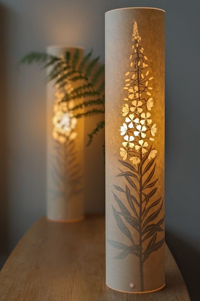 Craft Decorative Lighting for Cozy Ambience 2 Decorative cylindrical lamps with floral designs emit a warm glow, enhancing cozy home ambiance. | Sky Rye Design Decorative cylindrical lamps with floral designs emit a warm glow, enhancing cozy home ambiance.