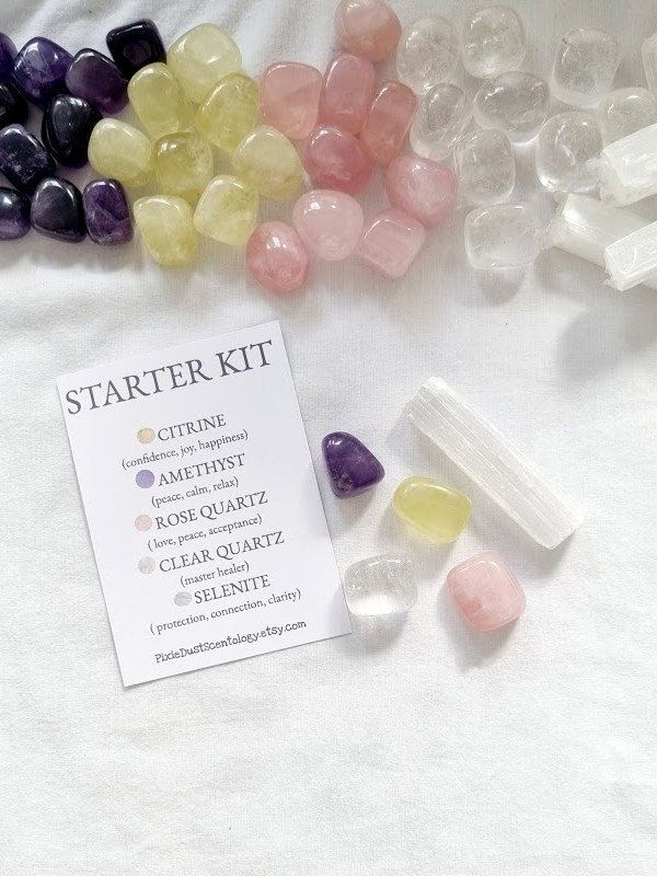 Crystal starter kit with amethyst, citrine, rose quartz, clear quartz, and selenite on a white background.
