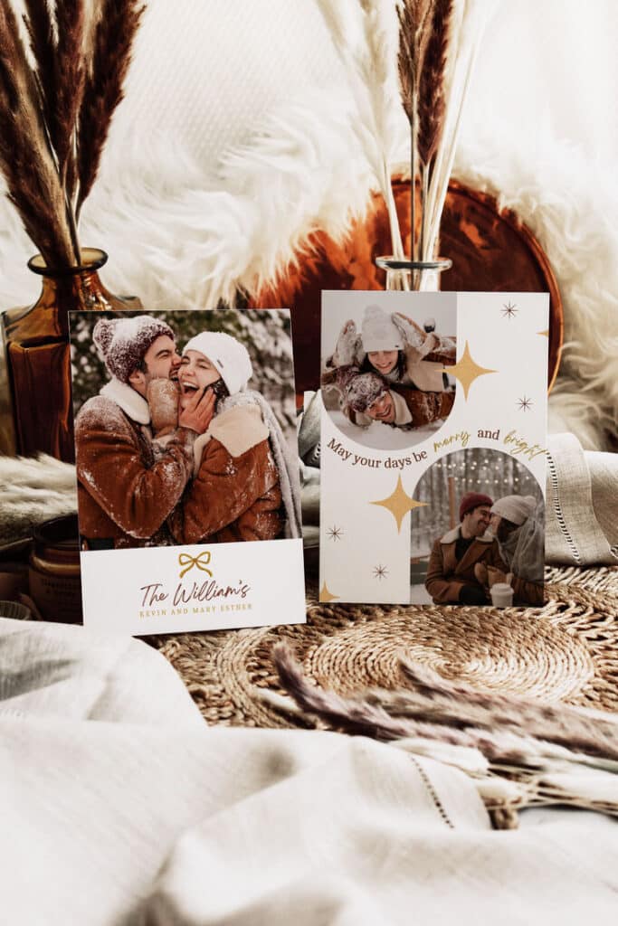 Festive holiday cards with happy couple in snowy setting, surrounded by cozy decor and dried pampas grass.