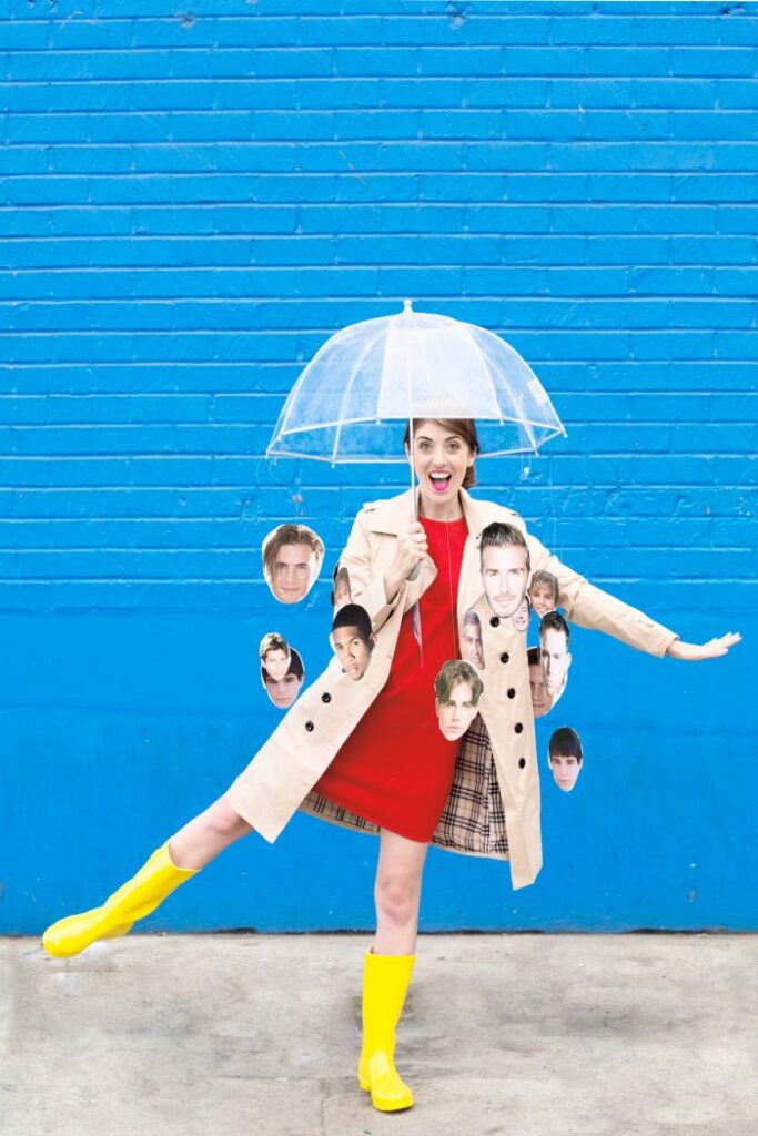 Woman in red dress with umbrella and celebrity faces, playful pose against blue wall.