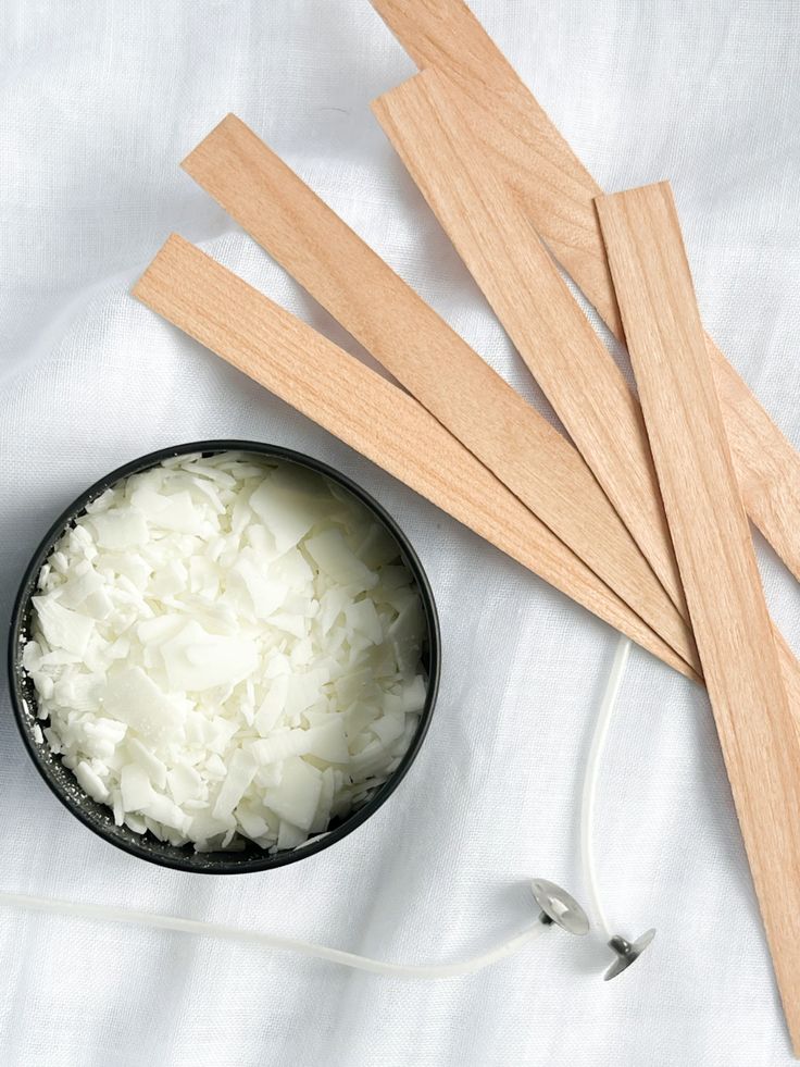 DIY Soy Candle Wooden candle wicks, soy wax flakes, and candle wicks on white fabric, perfect for DIY candle making projects. | Sky Rye Design Wooden candle wicks, soy wax flakes, and candle wicks on white fabric, perfect for DIY candle making projects.
