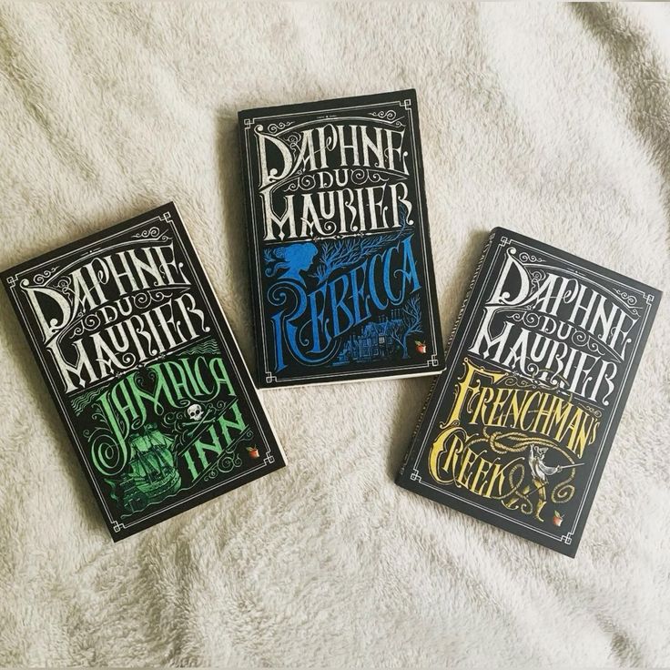 Daphne Du Maurier Three classic Daphne du Maurier novels: Jamaica Inn, Rebecca, and Frenchman's Creek on a soft, textured surface. | Sky Rye Design Three classic Daphne du Maurier novels: Jamaica Inn, Rebecca, and Frenchman's Creek on a soft, textured surface.