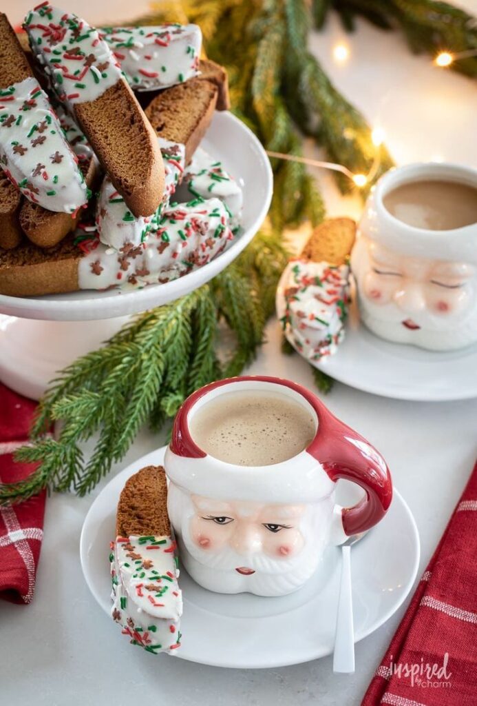 Delicious and Festive Gingerbread Biscotti gingerbread biscotti recipe coffee christmas Festive biscotti with Christmas sprinkles beside Santa mugs of coffee on a holiday-themed table setting. | Sky Rye Design Festive biscotti with Christmas sprinkles beside Santa mugs of coffee on a holiday-themed table setting.