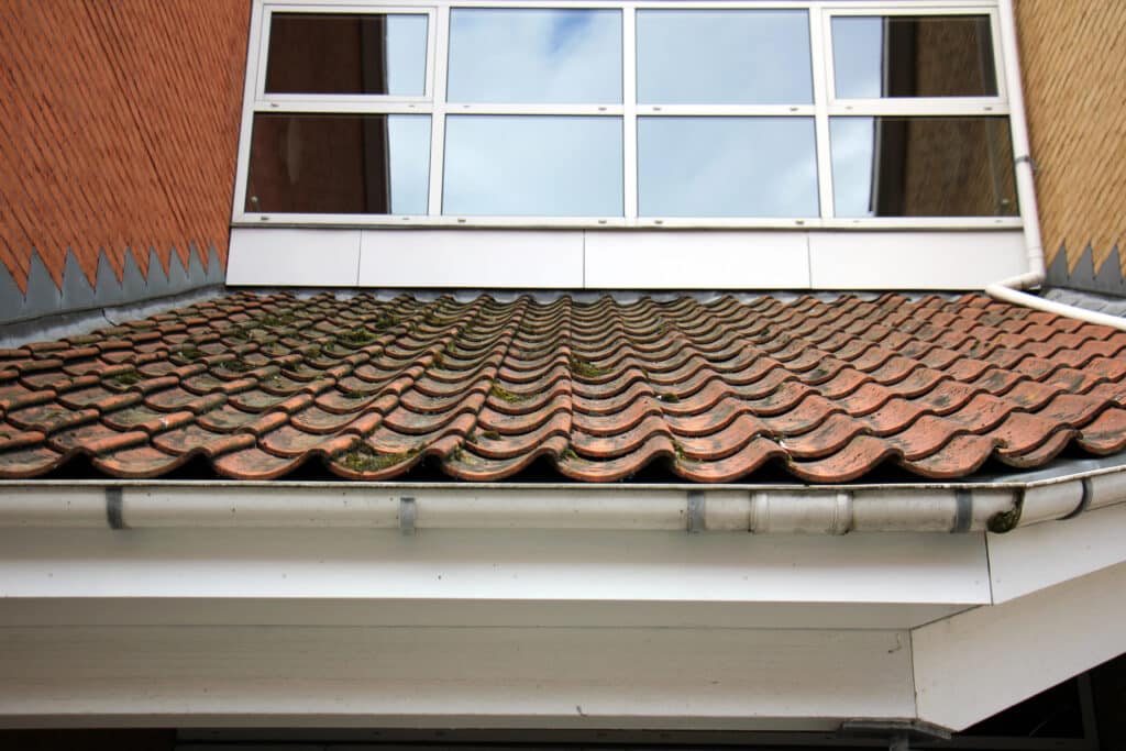 Depositphotos_110149980_XL Modern building facade with reflective windows and weathered terracotta roof tiles. | Sky Rye Design Modern building facade with reflective windows and weathered terracotta roof tiles.