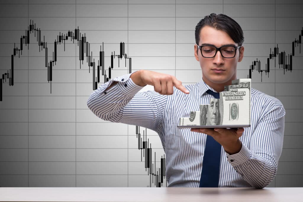 Depositphotos_122501356_XL Businessman analyzing financial growth with dollar bars in front of stock chart. | Sky Rye Design Businessman analyzing financial growth with dollar bars in front of stock chart.