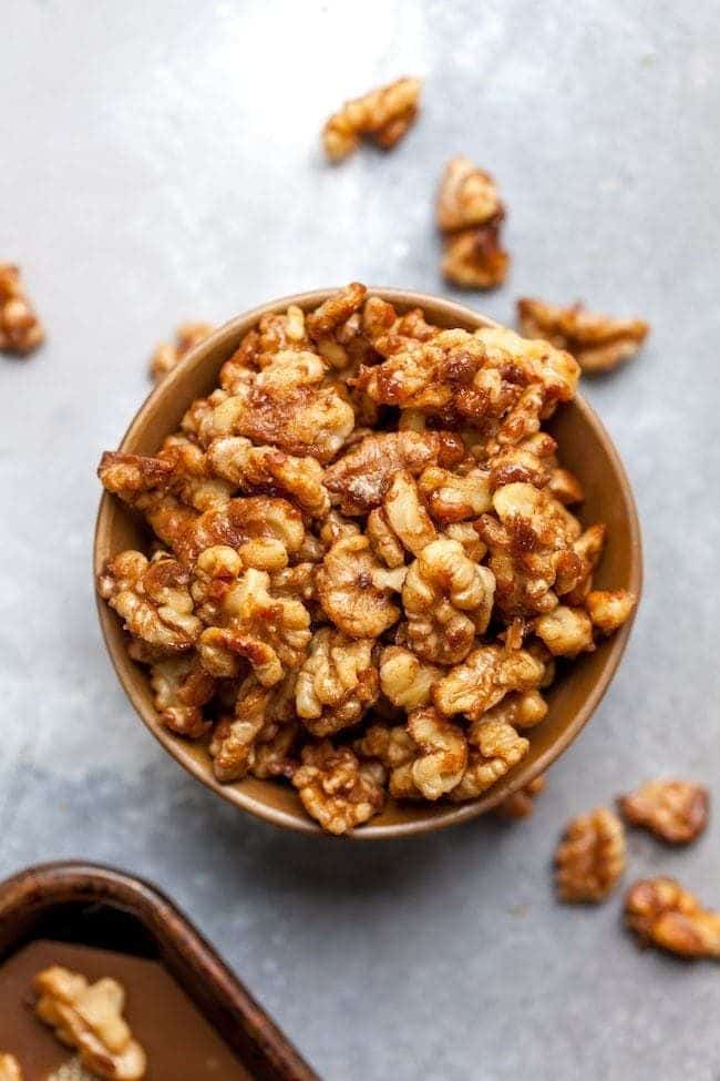 Easy Candied Walnuts - Two Peas Their Pod Bowl of caramelized walnuts on a table, perfect for snacking or adding to desserts. | Sky Rye Design Bowl of caramelized walnuts on a table, perfect for snacking or adding to desserts.