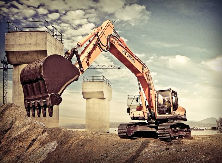 Excavator digging at a construction site with concrete pillars and cranes in the background.
