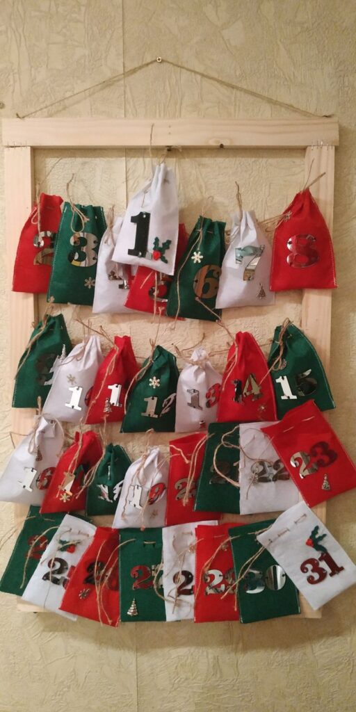 Felt Advent Calendar Colorful DIY advent calendar with numbered fabric bags hanging on a wooden frame, perfect for holiday countdown. | Sky Rye Design Colorful DIY advent calendar with numbered fabric bags hanging on a wooden frame, perfect for holiday countdown.
