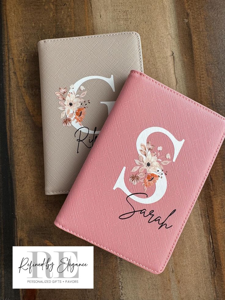 Two personalized notebooks with floral initials on a wooden surface, labeled Refined by Elegance.