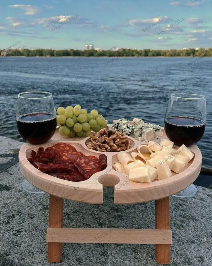 Folding Wine Table Wine Gifts Wine Lover Gift Outdoor Wine Holder Portable Picnic Wine Table Patio Table Charcuterie board with cheese, grapes, nuts, and wine by a serene lake. Perfect picnic setup with scenic view. | Sky Rye Design Charcuterie board with cheese, grapes, nuts, and wine by a serene lake. Perfect picnic setup with scenic view.