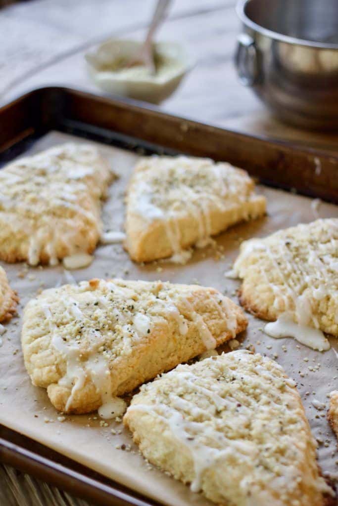 Fresh Ginger Lemon Scones Freshly baked scones with icing drizzle on a baking tray, perfect for breakfast or a sweet treat. | Sky Rye Design Freshly baked scones with icing drizzle on a baking tray, perfect for breakfast or a sweet treat.