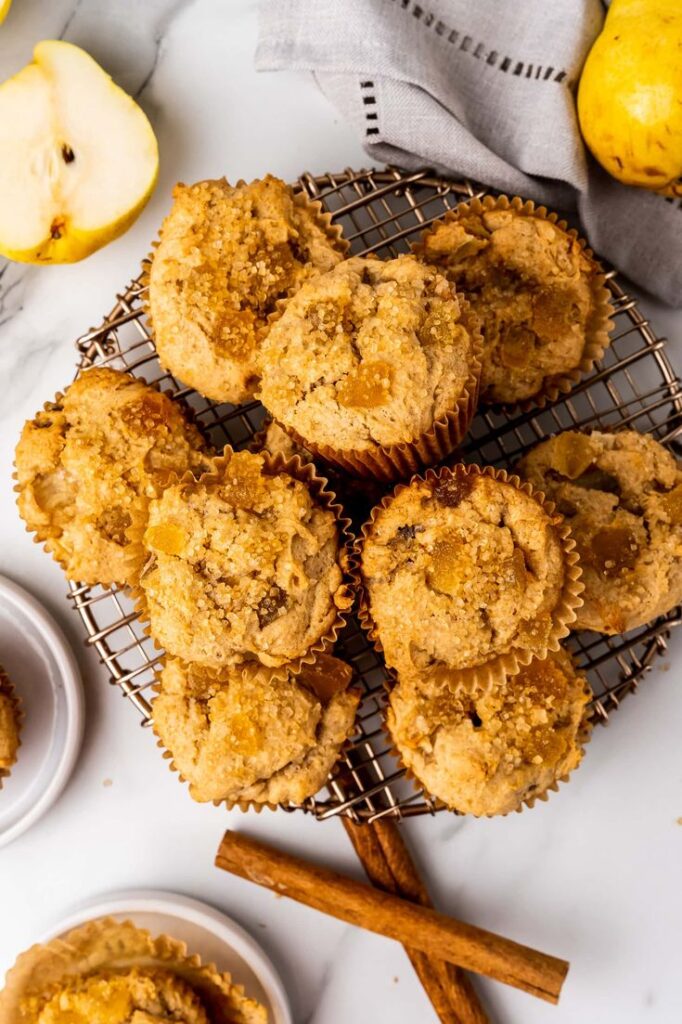 Ginger Pear Muffins Freshly baked pear muffins with cinnamon on a cooling rack, garnished with sugar crystals, ready to enjoy. | Sky Rye Design Freshly baked pear muffins with cinnamon on a cooling rack, garnished with sugar crystals, ready to enjoy.