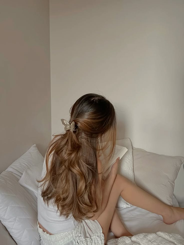 Hair goals ☁️🪞🎀 Dyson hair twinssteam Woman with long hair reading a book on a cozy bed, wearing casual home attire. | Sky Rye Design Woman with long hair reading a book on a cozy bed, wearing casual home attire.