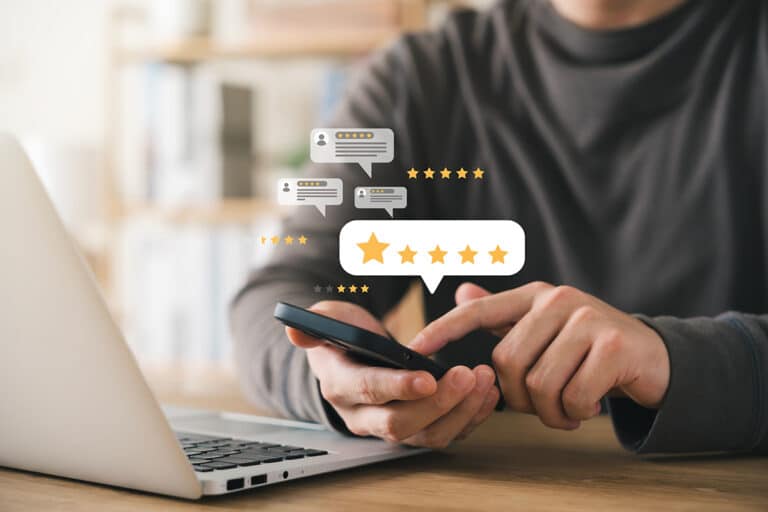 High-Quality Service Providers for Google Reviews Person using a smartphone to leave a five-star online review with feedback symbols. | Sky Rye Design Person using a smartphone to leave a five-star online review with feedback symbols.