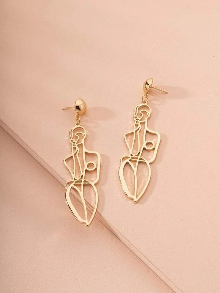 Hollow Out Figure Drop Earrings I Body Shape Earrings I Gold _ Etsy Abstract gold wire art earrings on a pastel pink background. | Sky Rye Design Abstract gold wire art earrings on a pastel pink background.