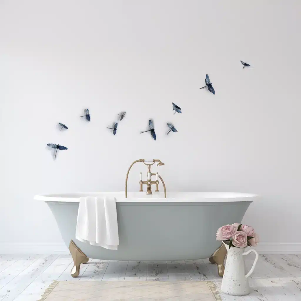 Horizontal_Dragonfly_mockup_45691c1c-2221-4f38-9297-cb419f5b23b6 Elegant bathroom with clawfoot tub, dragonfly wall decals, and vase of pink flowers for a serene, spa-like ambiance. | Sky Rye Design Elegant bathroom with clawfoot tub, dragonfly wall decals, and vase of pink flowers for a serene, spa-like ambiance.