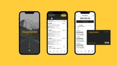 Three smartphones displaying a trucking app interface, featuring balance, invoices, and a black Visa card on a yellow background.