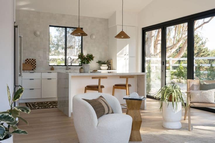 How a Compact ADU Lives Large with Texture and Light Modern kitchen with natural light, large windows, island seating, and stylish decor. Cozy and inviting space for gatherings. | Sky Rye Design Modern kitchen with natural light, large windows, island seating, and stylish decor. Cozy and inviting space for gatherings.
