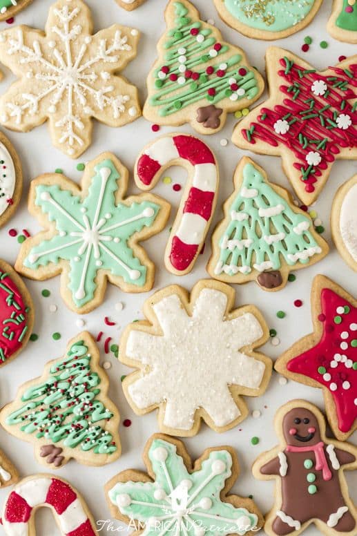 Assorted decorated Christmas cookies featuring snowflakes, trees, and candy canes with colorful icing and sprinkles.
