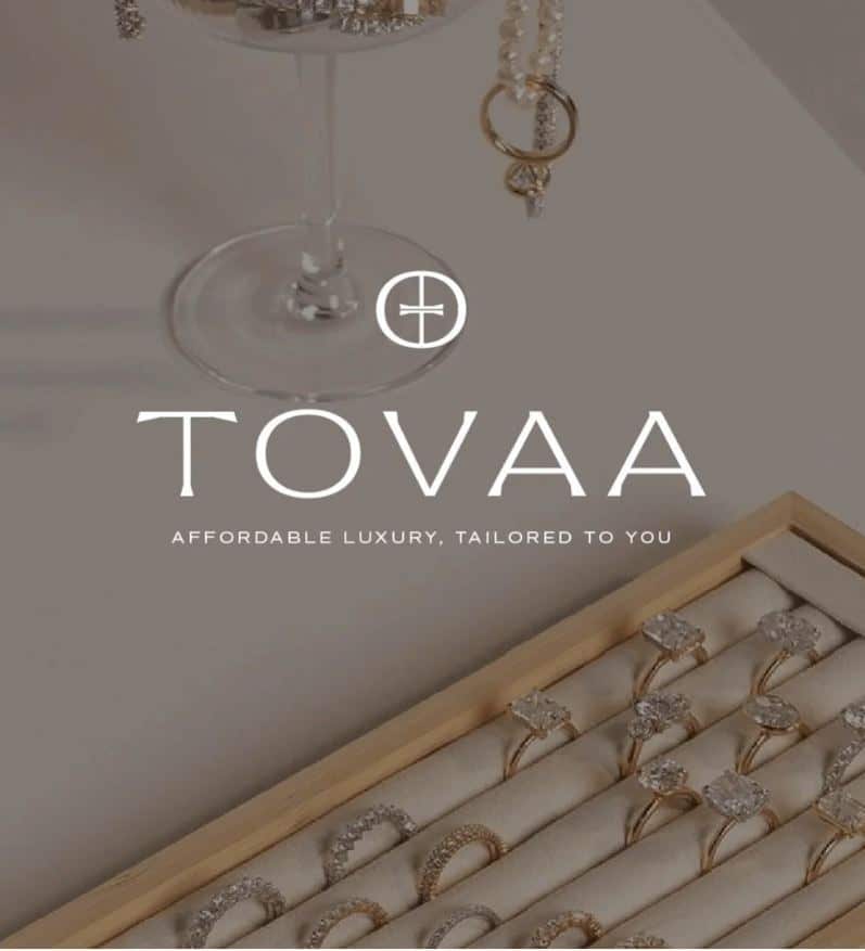 Elegant gold and diamond rings in a jewelry display box by Tovaa, showcasing affordable luxury and sophistication.
